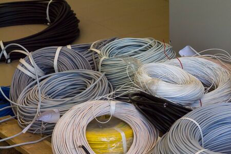 rolls of cable various colors and diameter on a wooden pallet