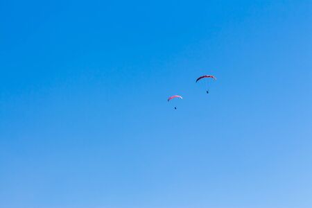 Sky Diving with space in solid blue skyの写真素材