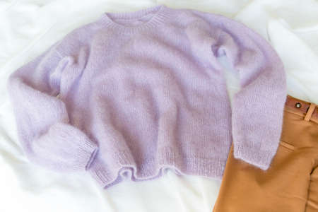 A cozy house, knitting, beautiful background. Stay home. Knitting, hobby, knitted sweater, pink sweater, pattern, knit, threads, wife, perfect woman, beautiful girl, charm. Beautiful hands.の写真素材