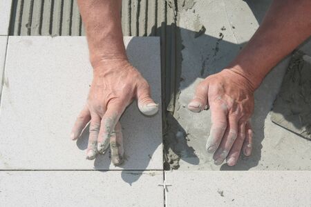 On this picture is hands, that work with grout.の写真素材