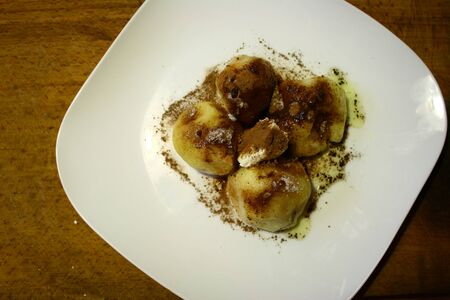 On this picture is apricot dumplings on white plate.の写真素材