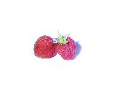 On this product photography are two raspberries.