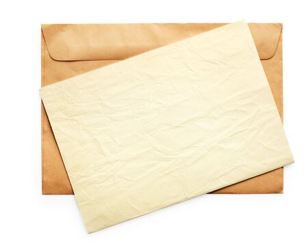 Brown envelope and yellow paper on it. Isolated on white backgroundの写真素材
