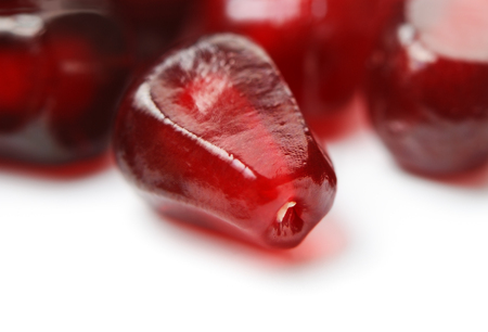 Close up of pomegranate seeds on white の写真素材