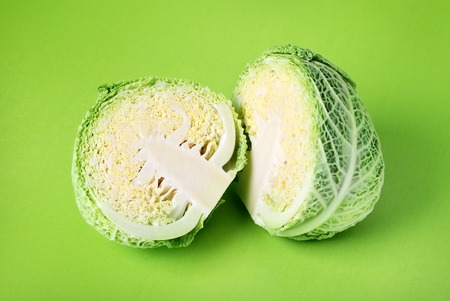 Savoy cabbage over green backgroung.の写真素材