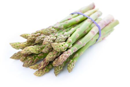 Bunch of fresh green asparagus isolated on white backgroundの写真素材