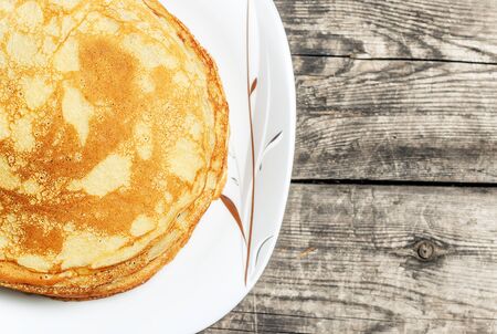 Fried pancakes on old wooden table. Top view