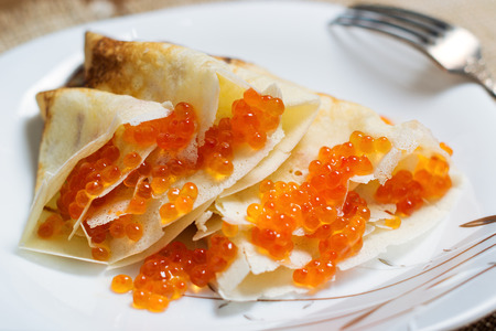 Homemade pancakes with red caviar on a plate. Shallow DOFの写真素材