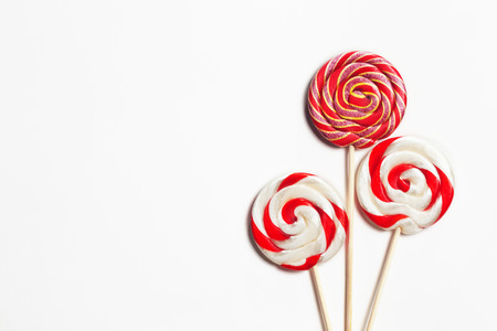 Lollipops on a stick on a white background. Flat lay. Shallow DOF. Copy spaceの写真素材