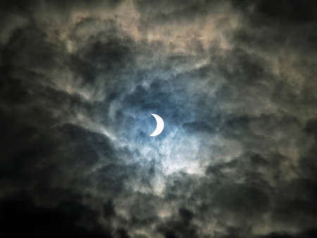 solar eclipse through the clouds