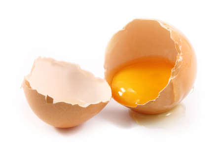 broken chicken eggs and egg yolk  isolated on white 