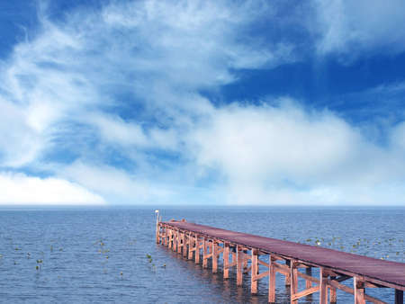 wooden jetty on the beautiful sea with blue sky and cloudsの写真素材