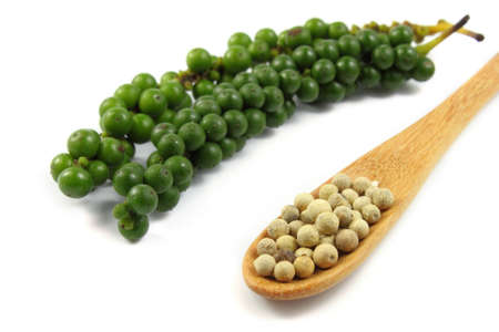 peppercorn in the wooden spoon on white backgroundの写真素材