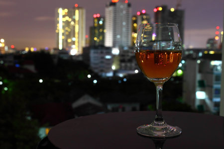 a beautiful wine glass and the city reflexの写真素材