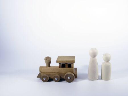 wooden train toy and wooden figurines of man and woman.concept travel.の写真素材