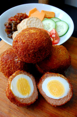 Scotch Eggs perfection platter served with crackers and pickles