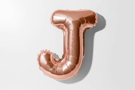 Letter J, Rose gold foil balloon alphabet isolated on a white background with Clipping Pathの写真素材