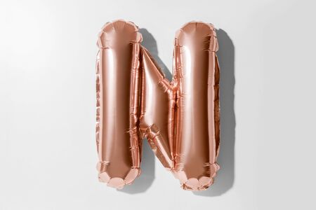 Letter N, Rose gold foil balloon alphabet isolated on a white background with Clipping Pathの写真素材