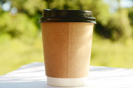 cup of tea in hand, cup of coffee and milk