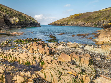 View from the beach at Port Quin, North Cornwall, England, as the tide goes out.