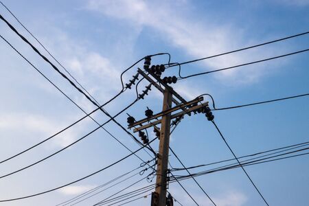 electric pole power lines and wires with blue sky.