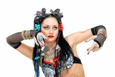 alluring young tribal dancer in pose on whiteの写真素材