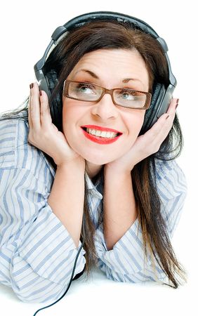 smiling young woman with head phone on whiteの写真素材