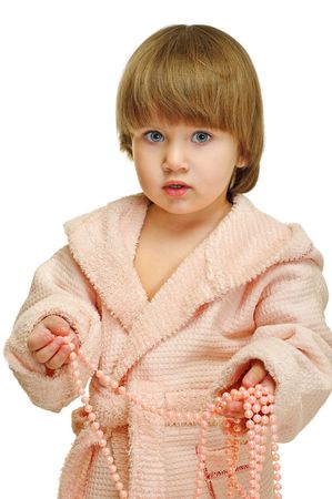 little girl in pink bathrobe with beads の写真素材