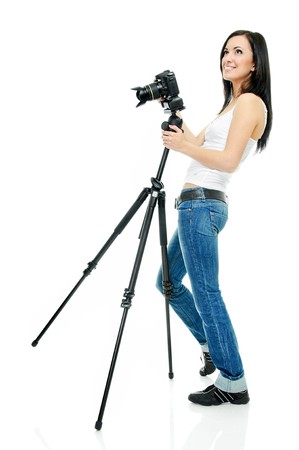 portrait of beauty brunette with camera on tripodの写真素材