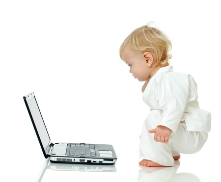 little boy in kimono about laptop on white backgroundの写真素材