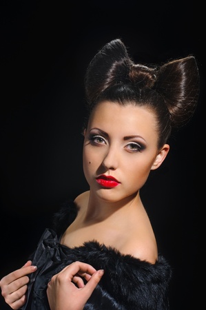 portrait of beautiful girl with bow coiffure on black の写真素材