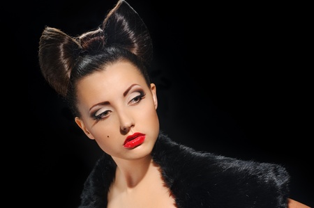 portrait of beautiful girl with bow coiffure on black の写真素材