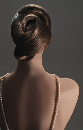 coiffure of beauty girl from back on greyの写真素材