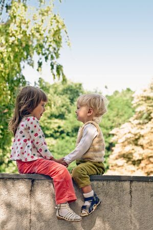playing little girl and boy in the park