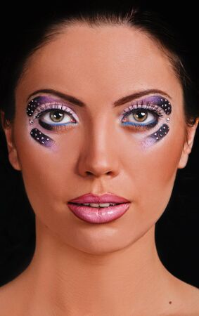 portrait of beautiful girl with art make up on black