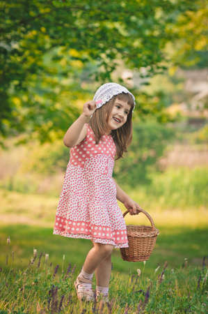 little girl in the forest with punnet の写真素材
