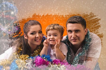 young mother little boy and young farther in decorations of new year with frozen window effect