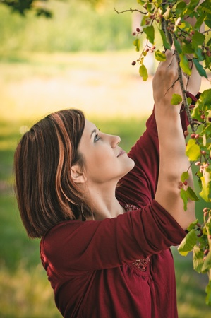 portrait of young woman with twig mulberryの写真素材