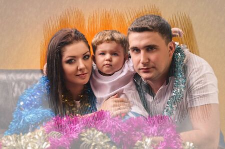 young mother little boy and young farther in decorations of new year with frozen window effectの写真素材