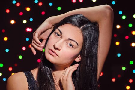 portrait of beautiful brunette on garland background の写真素材