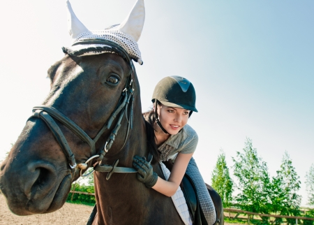 portrait young woman on horseback outdoorの写真素材