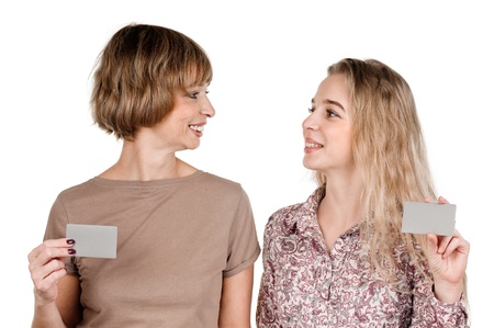 portrait of happy daughter and mother with cards on whiteの写真素材