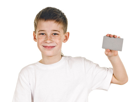 portrait of happy schoolboy with card on white の写真素材