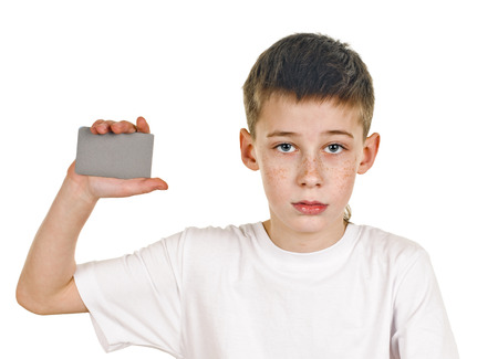 portrait of happy schoolboy with card on white の写真素材