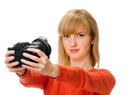 beauty woman photographs herself by camera on whiteの写真素材