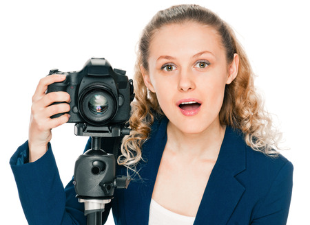 young woman photographer with camera on tripodの写真素材