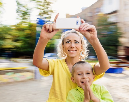 Family having fun on spinning roundabout. selfie Portrait. Naturally blur motionの写真素材