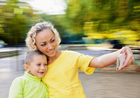 Family having fun on spinning roundabout. selfie Portrait. Naturally blur motionの写真素材