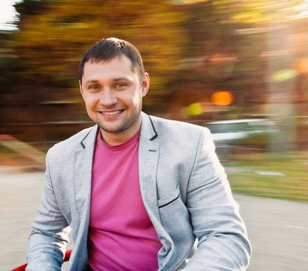 Handsome man in the park. background with natural motion blurの写真素材