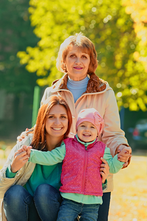 Portrait of three generations women in the autumn parkの写真素材